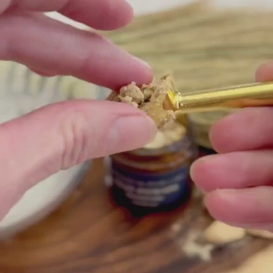 Simply Wild Clay Pomade texture — a small amount shown between fingertips
