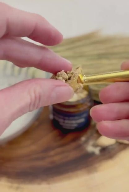 Simply Wild Clay Pomade texture — a small amount shown between fingertips